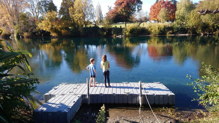 Teach a kid to fish for trout from Riverside Apartment Taupo