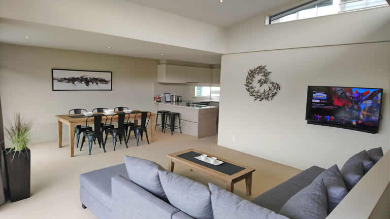 Apartment One dining and living area with views over the Waikato river