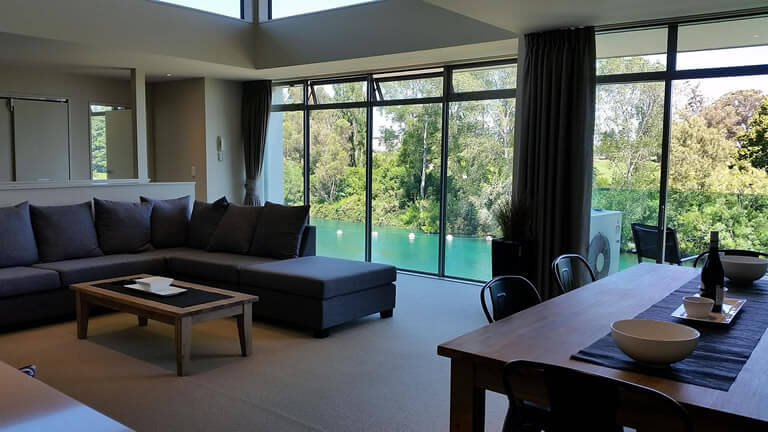 Apartment One dining and living area with views over the Waikato river